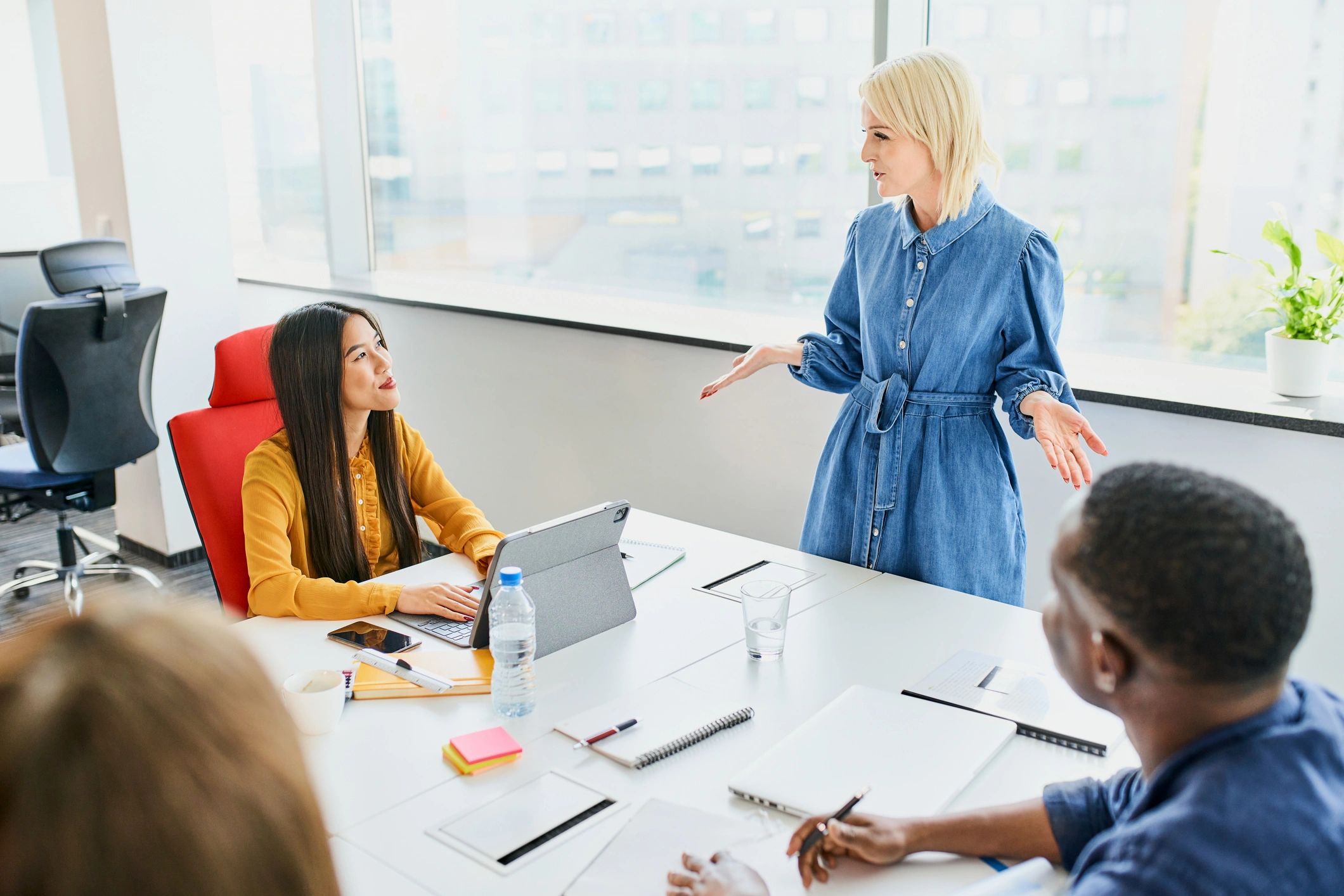 Professional woman presenting ideas to a small team