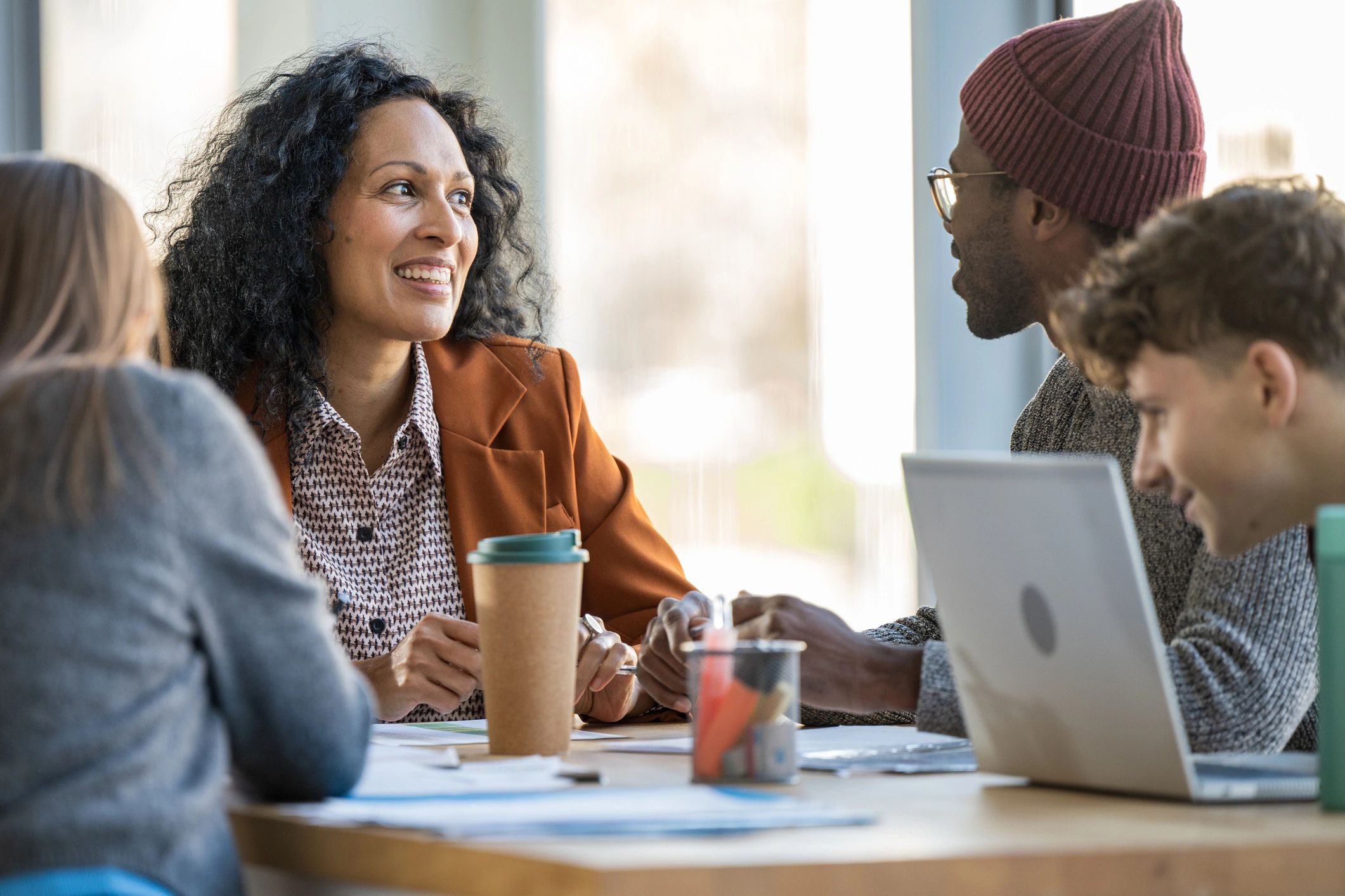 Women collaborating around a table in a coaching session